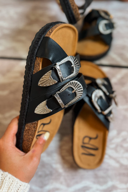 Side view black western slide sandals featuring buckle accents and a cushioned footbed