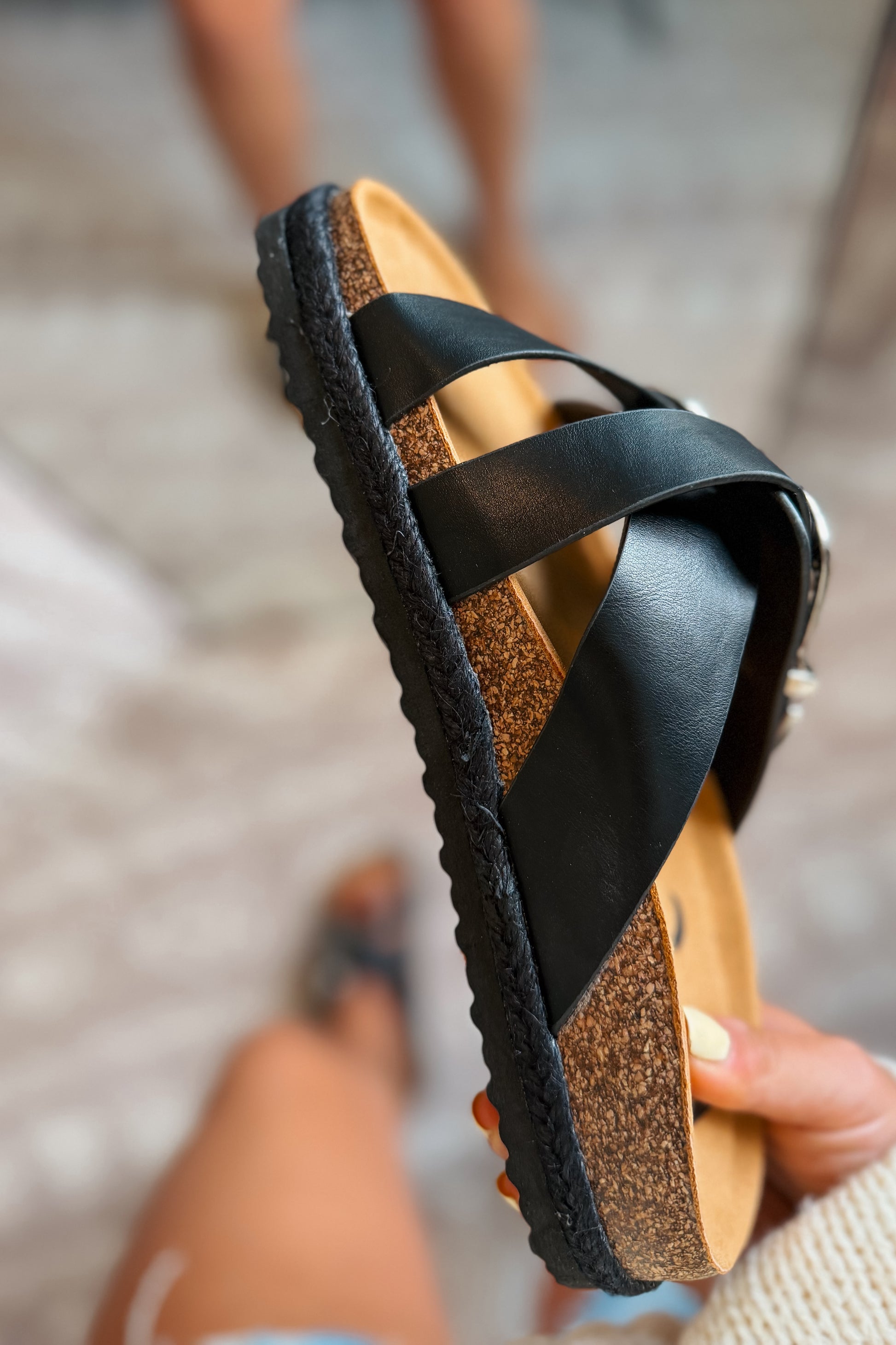 Side view black western slide sandals featuring a braided trim detail