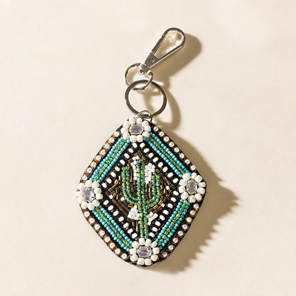 Green beaded cactus keychain with decorative bead details, designed to attach to keys or a bag.