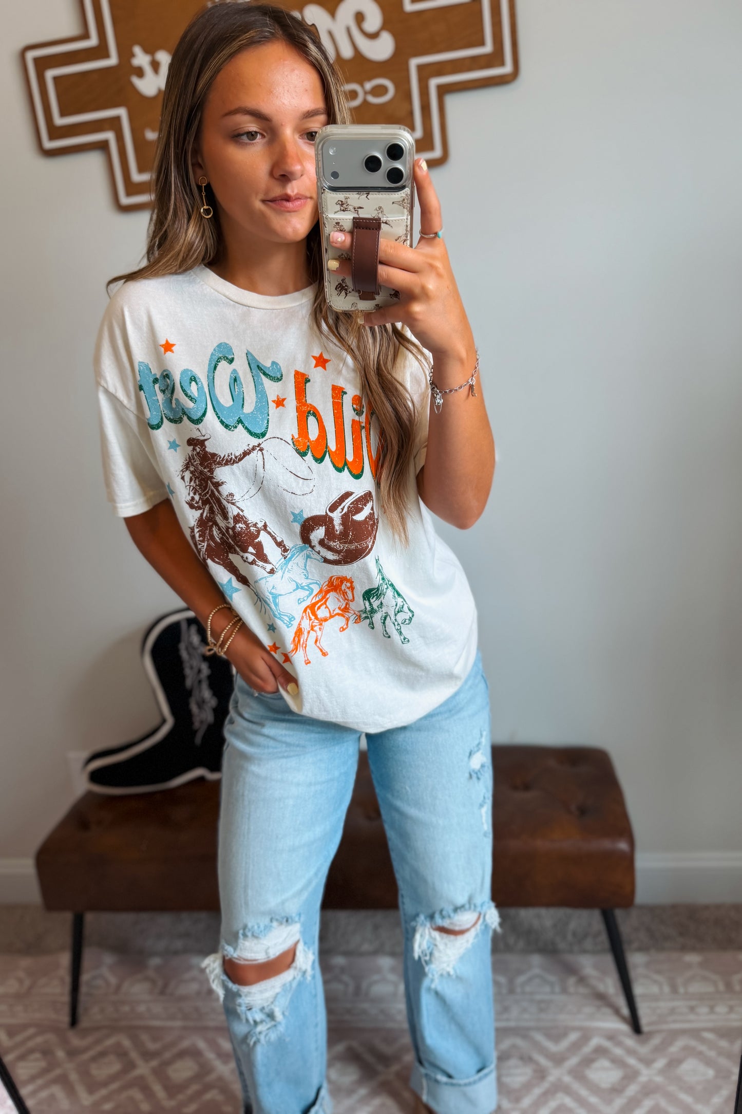 White Wild West graphic tee featuring western-inspired artwork.
