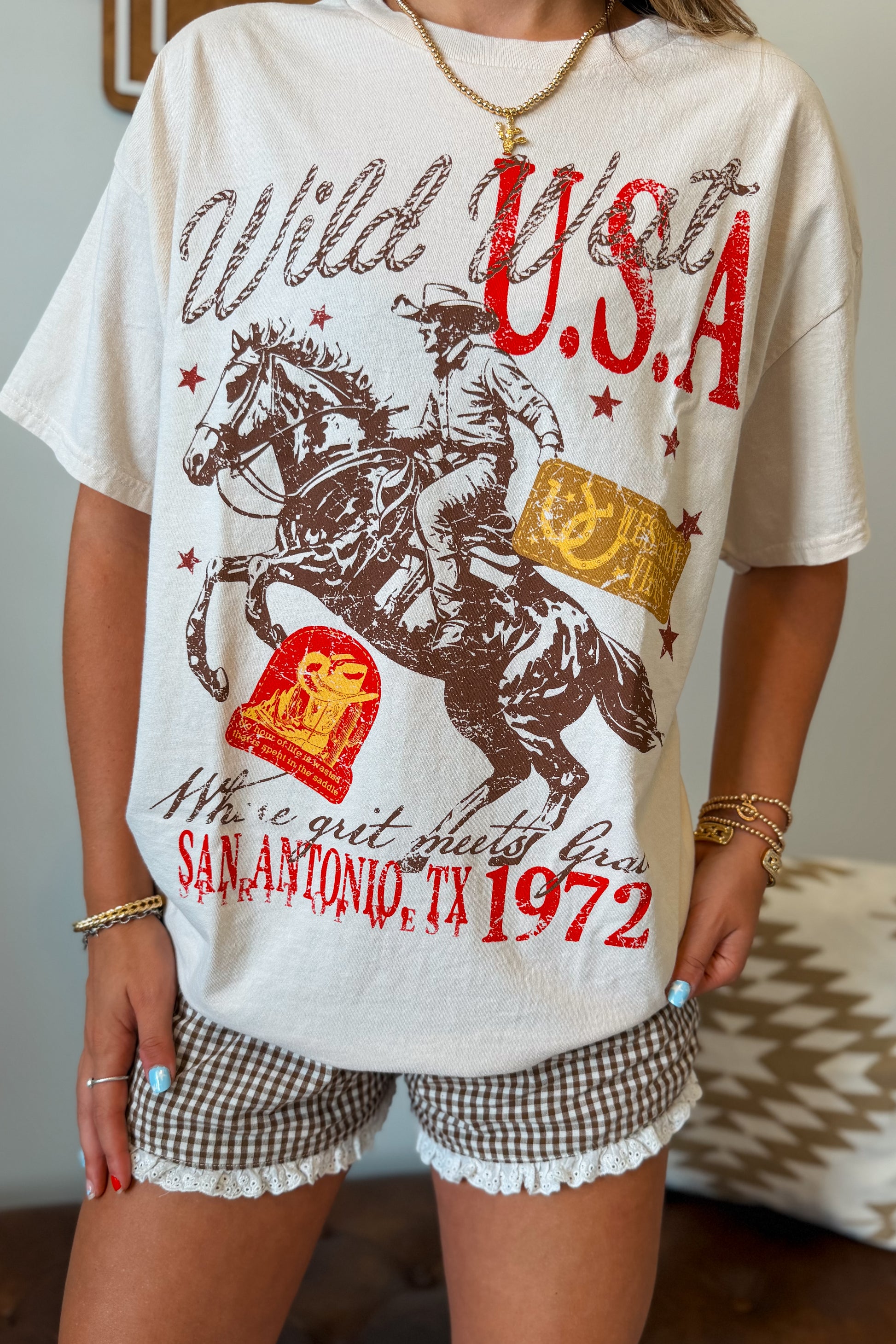 Close-up of the western-inspired graphic printed on the front of the oversized tee.